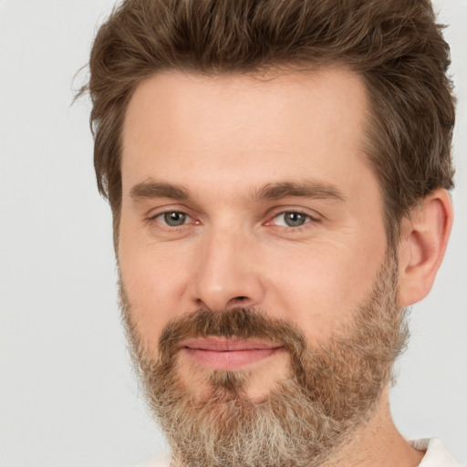 Joyful white adult male with short  brown hair and brown eyes