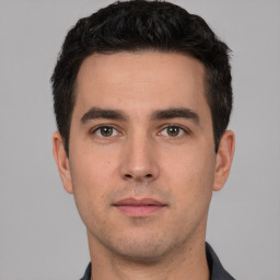 Neutral white young-adult male with short  black hair and brown eyes