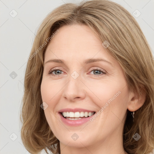 Joyful white young-adult female with medium  brown hair and green eyes