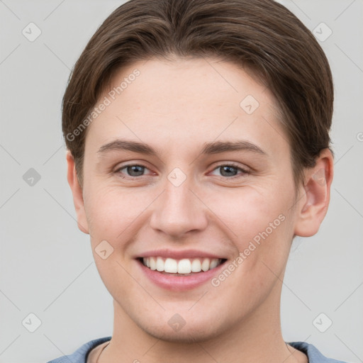 Joyful white young-adult female with short  brown hair and grey eyes