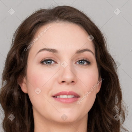 Joyful white young-adult female with long  brown hair and blue eyes