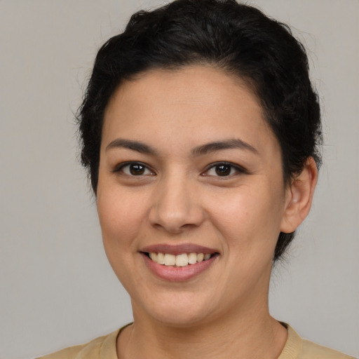 Joyful latino young-adult female with short  brown hair and brown eyes