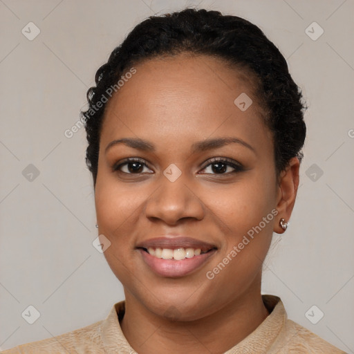 Joyful black young-adult female with short  black hair and brown eyes