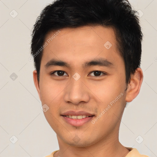 Joyful asian young-adult male with short  black hair and brown eyes