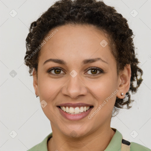 Joyful latino young-adult female with short  brown hair and brown eyes