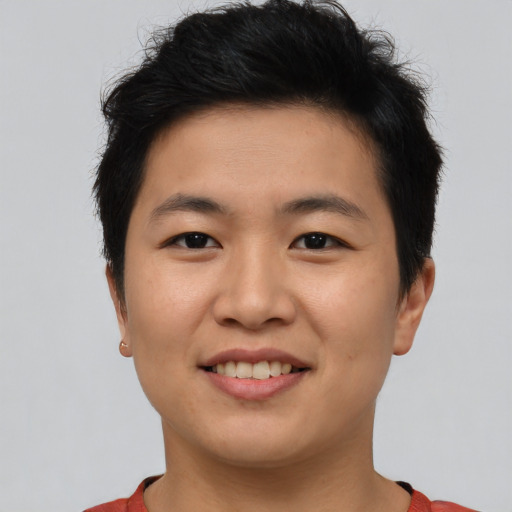 Joyful asian young-adult male with short  brown hair and brown eyes