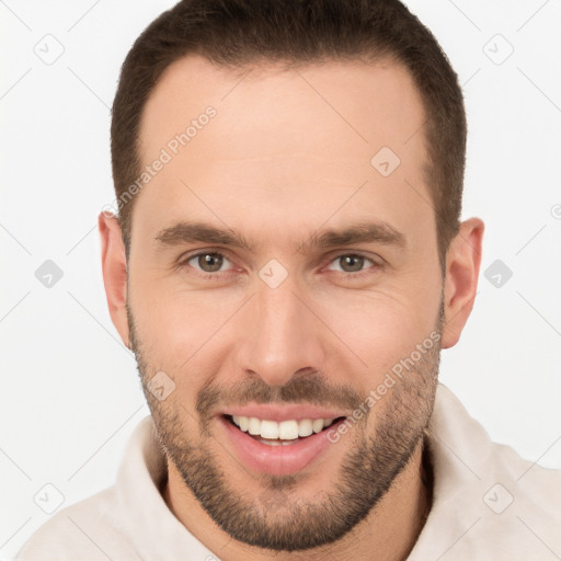 Joyful white young-adult male with short  brown hair and brown eyes