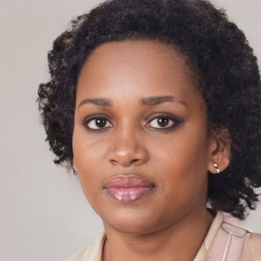 Joyful black young-adult female with medium  black hair and brown eyes