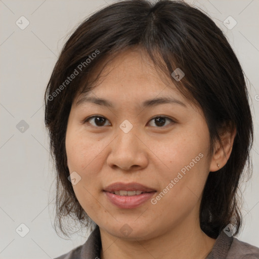 Joyful white adult female with medium  brown hair and brown eyes