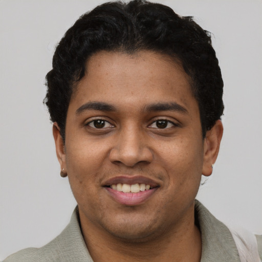 Joyful black young-adult male with short  black hair and brown eyes
