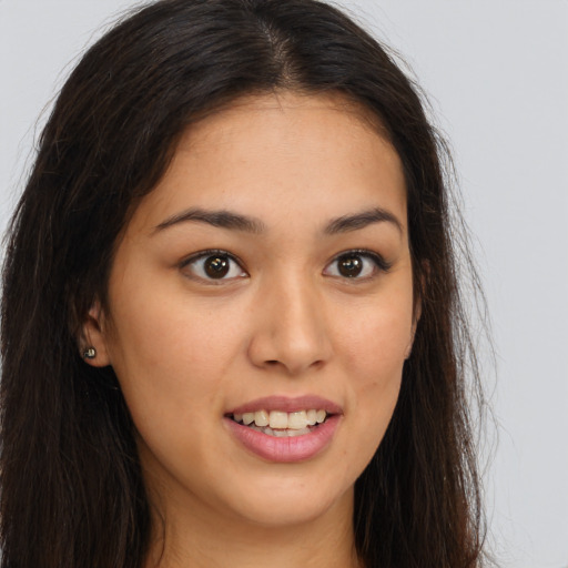 Joyful white young-adult female with long  brown hair and brown eyes