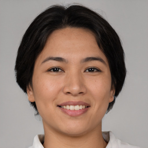 Joyful asian young-adult female with medium  brown hair and brown eyes