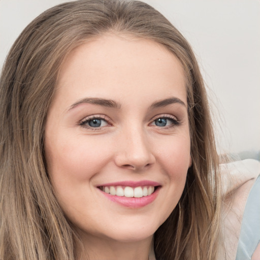 Joyful white young-adult female with long  brown hair and green eyes