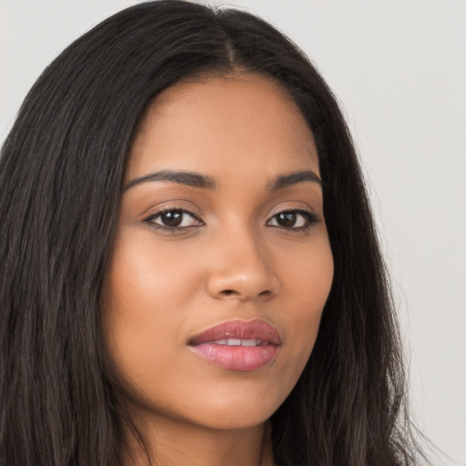 Joyful latino young-adult female with long  brown hair and brown eyes