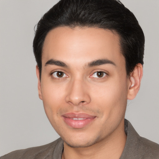 Joyful latino young-adult male with short  brown hair and brown eyes