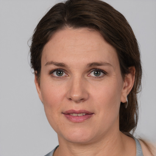 Joyful white adult female with medium  brown hair and brown eyes