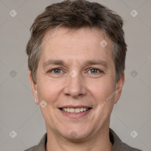 Joyful white adult male with short  brown hair and grey eyes