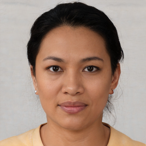 Joyful latino young-adult female with short  black hair and brown eyes