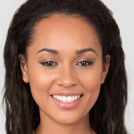 Joyful white young-adult female with long  brown hair and brown eyes