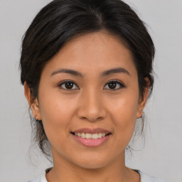 Joyful asian young-adult female with medium  brown hair and brown eyes