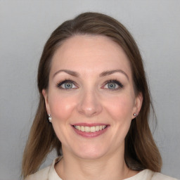 Joyful white young-adult female with medium  brown hair and blue eyes