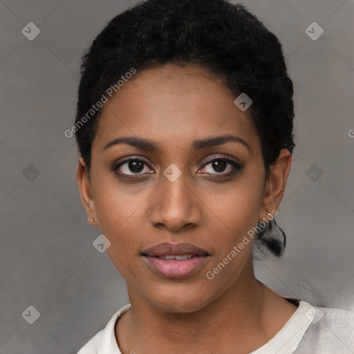 Joyful black young-adult female with short  black hair and brown eyes