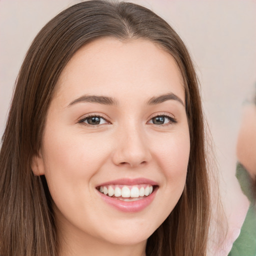 Joyful white young-adult female with long  brown hair and brown eyes