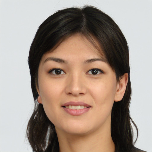Joyful asian young-adult female with long  brown hair and brown eyes