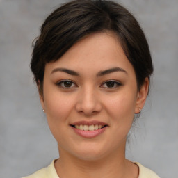 Joyful asian young-adult female with medium  brown hair and brown eyes