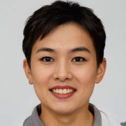 Joyful asian young-adult female with short  brown hair and brown eyes