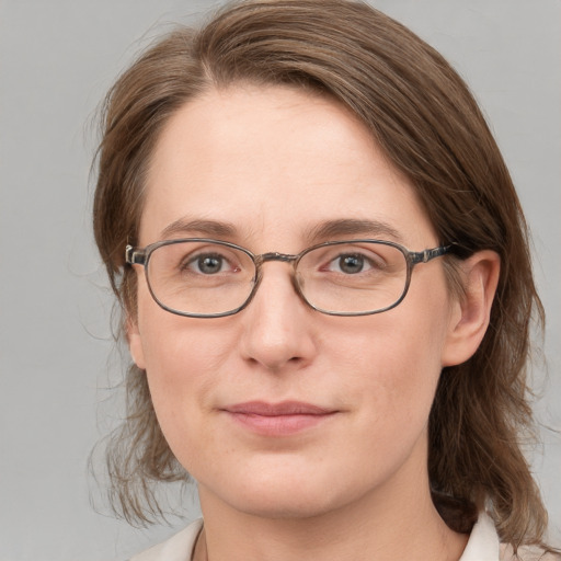 Joyful white adult female with medium  brown hair and blue eyes