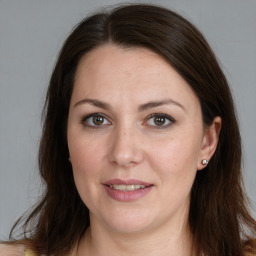 Joyful white adult female with long  brown hair and brown eyes