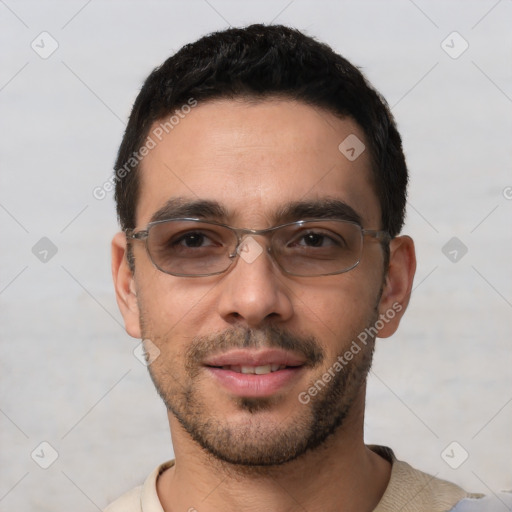 Joyful white young-adult male with short  black hair and brown eyes