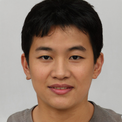 Joyful asian young-adult male with short  black hair and brown eyes