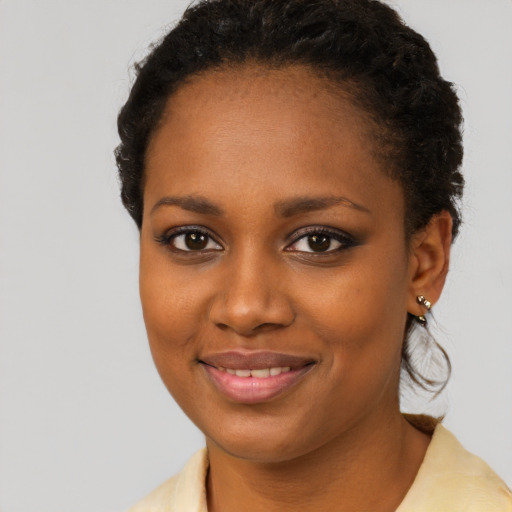 Joyful black young-adult female with short  brown hair and brown eyes