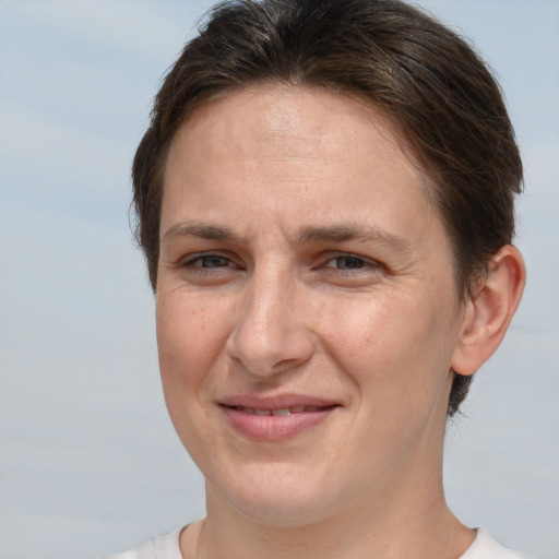 Joyful white adult female with short  brown hair and brown eyes