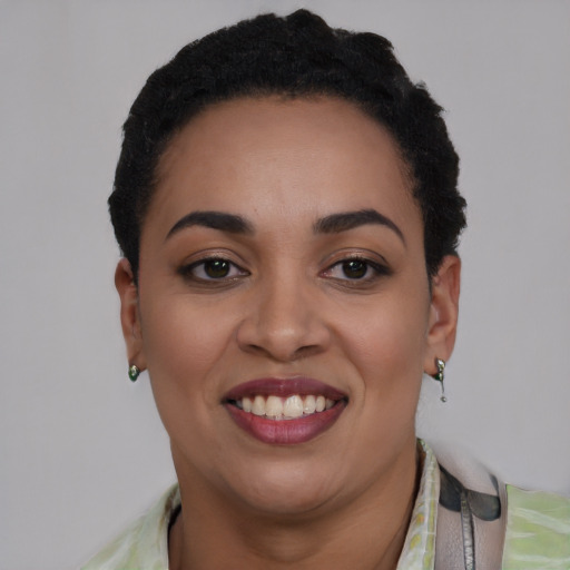 Joyful latino young-adult female with short  black hair and brown eyes