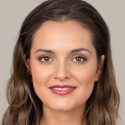 Joyful white young-adult female with long  brown hair and brown eyes