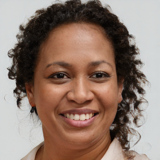 Joyful black adult female with medium  brown hair and brown eyes