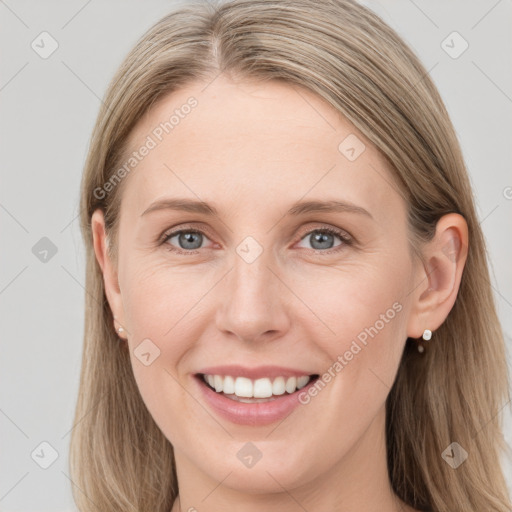 Joyful white young-adult female with long  brown hair and blue eyes