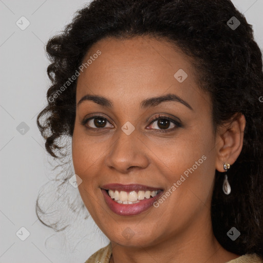 Joyful black young-adult female with long  brown hair and brown eyes