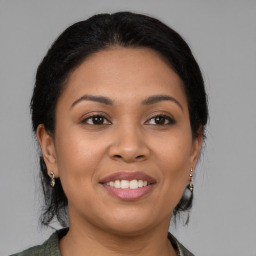 Joyful latino young-adult female with medium  brown hair and brown eyes