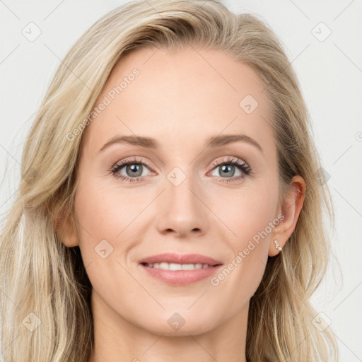 Joyful white young-adult female with long  brown hair and blue eyes