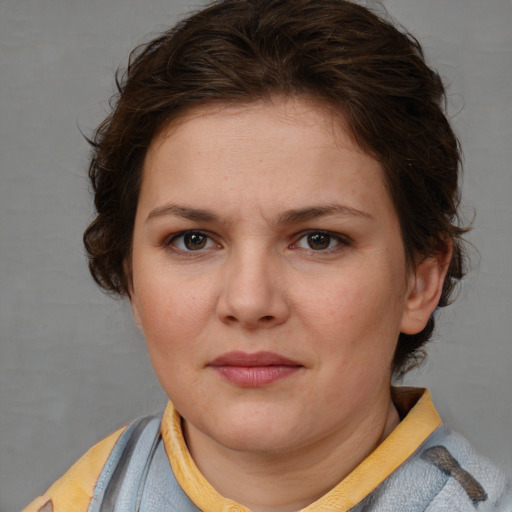 Joyful white young-adult female with medium  brown hair and blue eyes