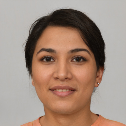 Joyful latino young-adult female with short  brown hair and brown eyes