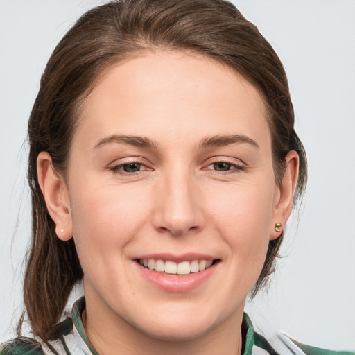 Joyful white young-adult female with medium  brown hair and grey eyes