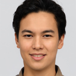 Joyful asian young-adult male with short  brown hair and brown eyes