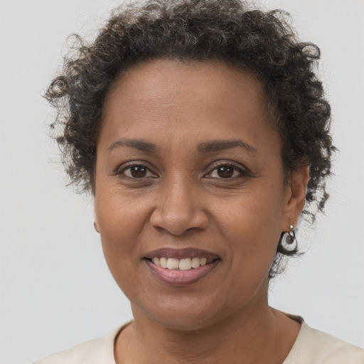 Joyful black adult female with short  brown hair and brown eyes