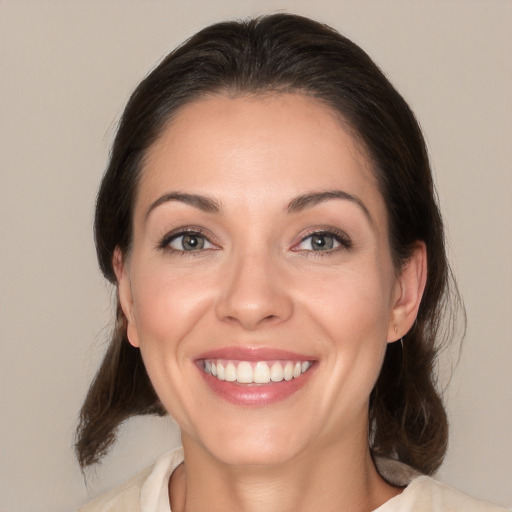 Joyful white young-adult female with medium  brown hair and brown eyes