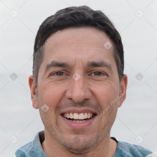 Joyful white adult male with short  brown hair and brown eyes